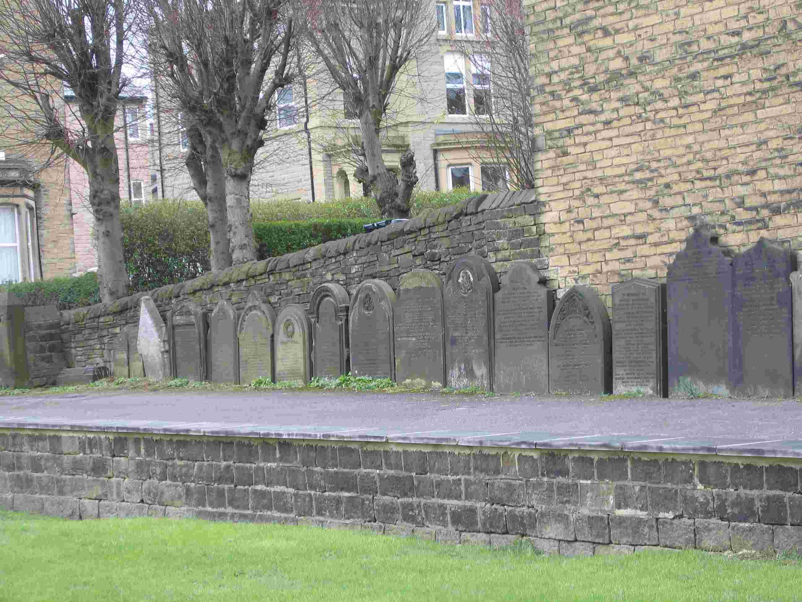 Tombstones placed against wall in front of main entrance to St Paul's Church, Shipley, Diocese of Bradford